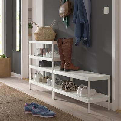 Organized entryway with white MACKAPÄR shoe rack holding boots, sneakers, and a basket with a coat and bag on hooks above.