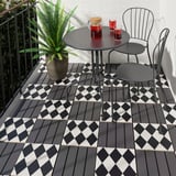 Checkered MÄLLSTEN tiles on small balcony with table, chairs, and plant.