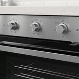 Modern oven with sleek metallic knobs and digital controls. Displays temperature and cooking settings, suitable for various kitchen tasks.