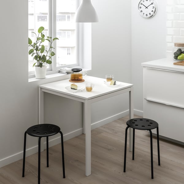 MELLTORP white table with black stools, plant, clock, teapot, cake, cozy.