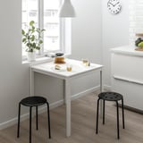 MELLTORP white table with black stools, plant, clock, teapot, cake, cozy.
