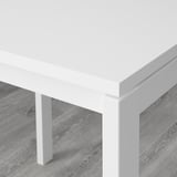 Close-up of durable, white MELLTORP table corner on stylish wood floor.