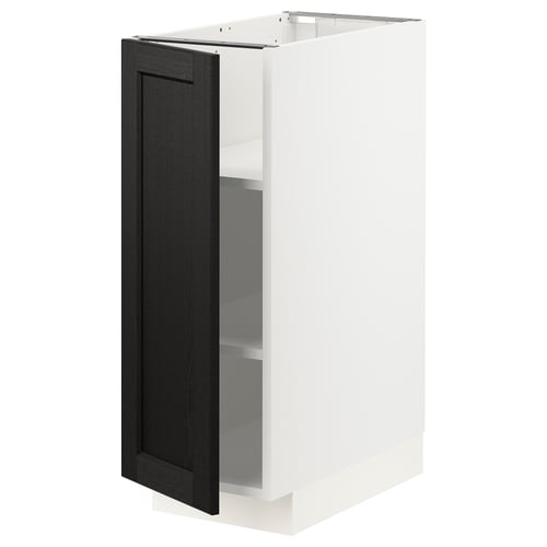 Open white cabinet with dark stained door. Traditional kitchen storage, adjustable shelves.