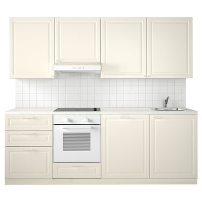 Minimalist white kitchen setup with cream cabinets, sink, and oven. Bright and modern design, ideal for small spaces.