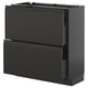A modern black METOD kitchen cabinet with sleek handles and a high drawer.