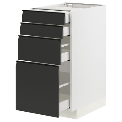 Modern kitchen unit with four black drawers, sleek design and matte finish.