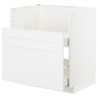 White METOD kitchen unit with glossy modern design, sleek lines, and open drawer.