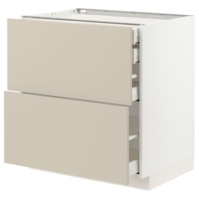 A white and beige kitchen cabinet from the METOD system, featuring two large drawers and one medium drawer.