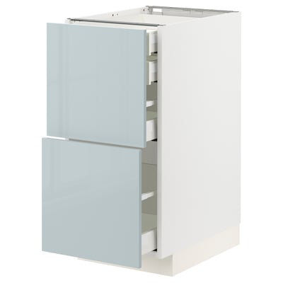 Modern kitchen cabinet with gray-blue high-gloss doors and white sides, featuring multiple drawers and a sleek design.