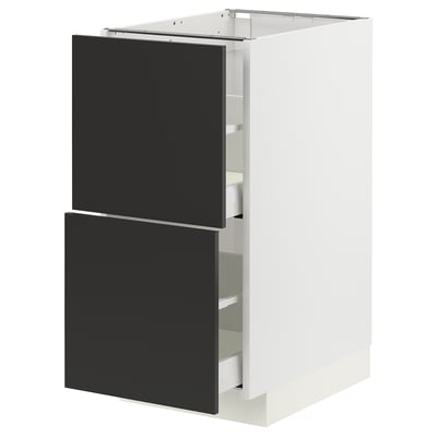 Modern kitchen unit, white with black drawers, sleek design.