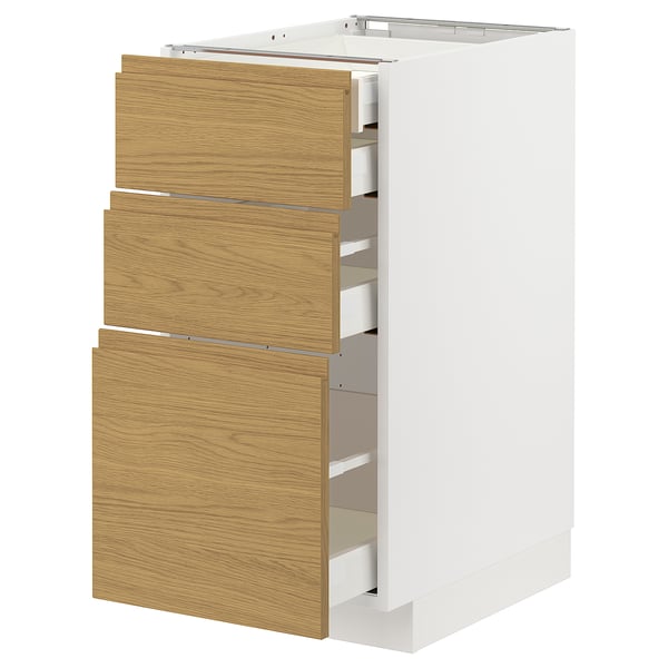 A white METOD kitchen cabinet with three light wooden drawers, each featuring a minimalist design with integrated handles.