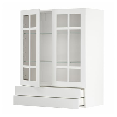 A white METOD kitchen cabinet with glass doors and drawers. It a modern, minimalist design with sleek lines and glass inserts.