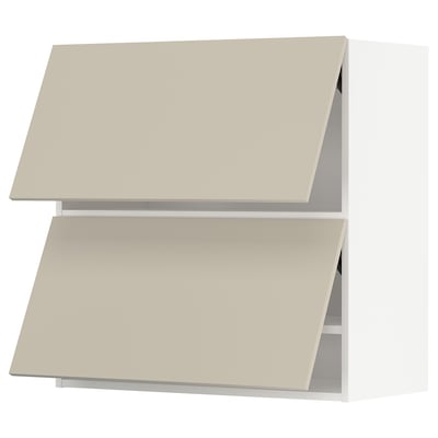 Two beige METOD kitchen cabinets with flat, angular design and smooth surfaces.