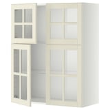 A white, wall-mounted kitchen cabinet set with glass doors, featuring a traditional design and adjustable shelves.