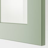 Close-up of modern green kitchen cabinet, showcasing sleek design and sturdy construction.