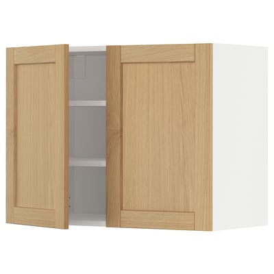 The METOD kitchen wall cabinet with light oak doors. It has a framed design with beveled edges. One door is open, revealing inner shelves.