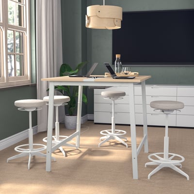 Modern MITTZON table set with stools in home office, surrounded by plant, laptop, and wine.
