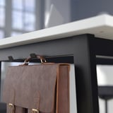 Close-up of MITTZON high conference tables footrest for standing comfort.