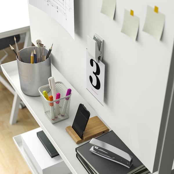 Small shelf for pens, phone, and papers, easy to move.