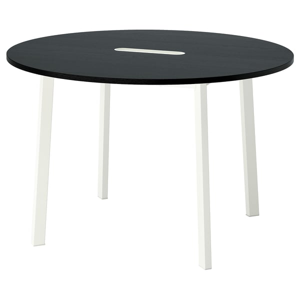 A black MITTZON round dining table with four white legs. It a stain-resistant top.