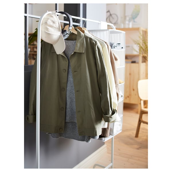 A MULIG green jacket on a white clothing rack with hooks and a hanging bag.