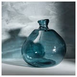 Teal recycled glass vase with bubble texture and rounded shape.