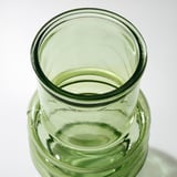 Green glass vase, recycled, textured surface.