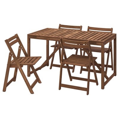 Wooden outdoor furniture set, includes rectangular table & four foldable chairs. Made of brown acacia wood, ideal for outdoor use.