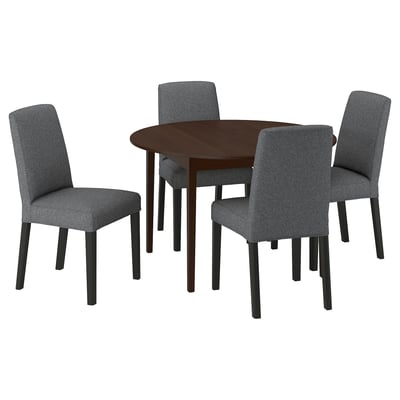 Dark wood round dining table with four grey fabric chairs, sleek design, great for small spaces.