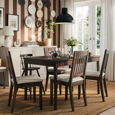Compact dining set with table, chairs, and sideboard in cozy room.