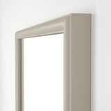 Modern beveled edge mirror, white frame, vertical orientation. Elegant, stylish design.