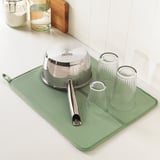 Silverware, glasses, jars on mat, cutting board. This retains the key components and reduces the number of words.