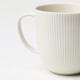Elegant textured white mug, smooth handle, quality porcelain feel.