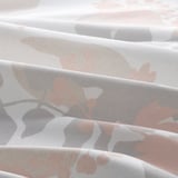 Close-up of textured tablecloth with leaf pattern, smooth and easy to clean.