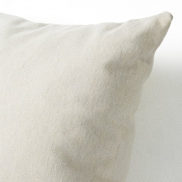 Close-up of a recycled cotton and polyester cushion. Natural color variations and visible stitching highlight its eco-friendly and unique texture.