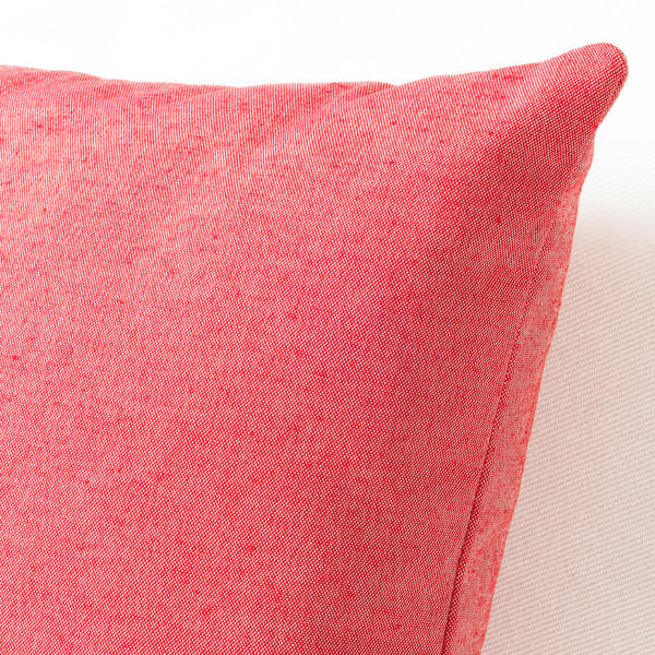 Red throw pillow with a smooth texture, featuring natural color variations, showcasing high-quality recycled materials.