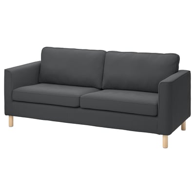 A PÄRUP sofa in dark grey corduroy with light wooden legs, featuring a modern and sleek design.