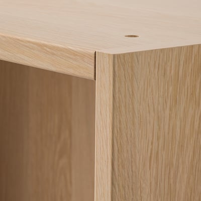 Close-up of sleek, light wood wardrobe, showing smooth finish and precise joinery.