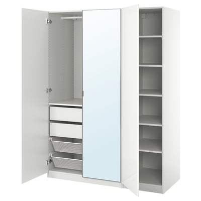 An open white PAX wardrobe with multiple storage compartments, drawers, and a mirror.