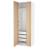 White and wood-textured PAX wardrobe. It has multiple drawers and compartments, standing vertically. A sleek, modern design.