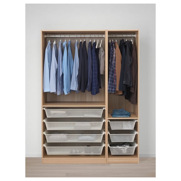 Wooden closet with hanging shirts, jackets, and foldable baskets for storage.