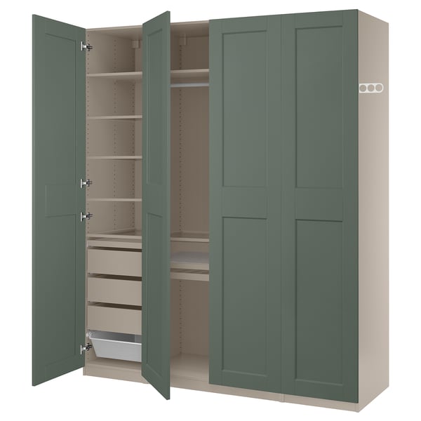 A green ikea PAX wardrobe with open doors, revealing shelves and storage inside.