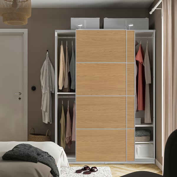 Modern sliding closet with hanging clothes, open to show interior storage and shelves.