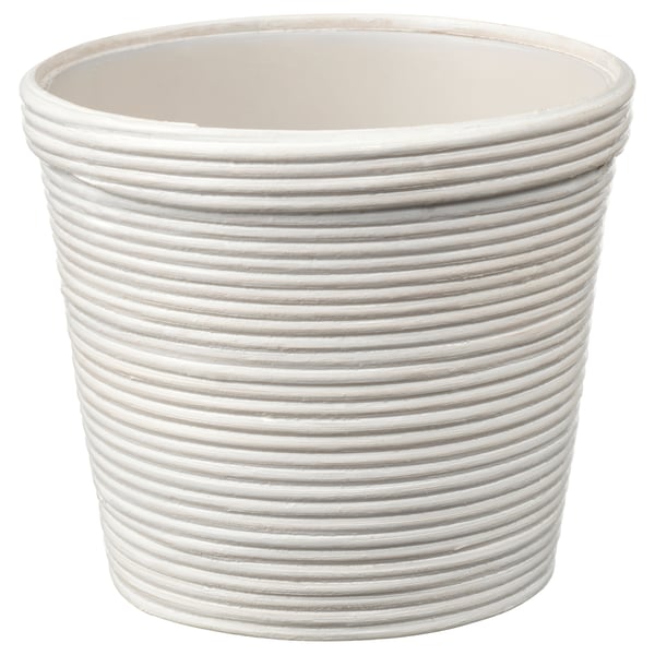 The PEKANNÖT planter is white, cylindrical with vertical ridges, made of rattan and plastic. It stands alone, simple yet stylish for any decor.