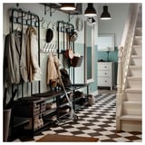 Coat rack, shoe storage, bench, grey checked floor, helmets, baskets.