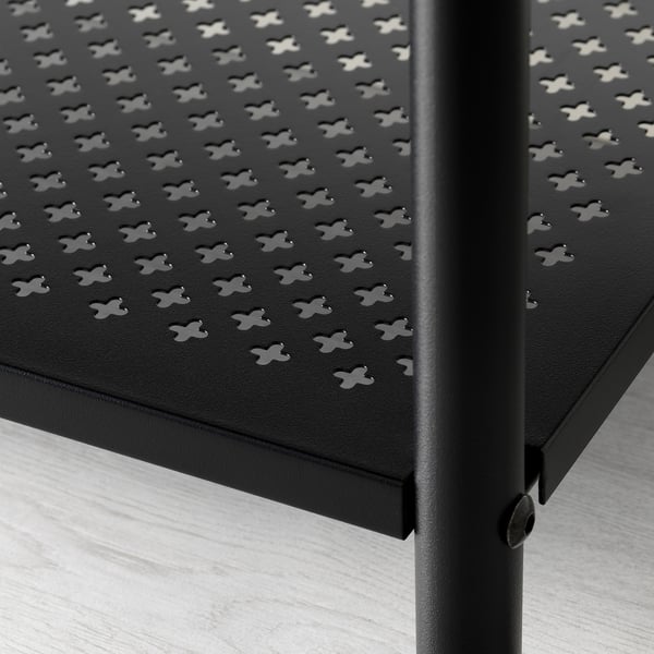 Black metal shelf with perforated pattern, mounted on a vertical post. Close-up showcasing design and quality.
