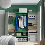 Modern bedroom closet with green PLATSA units, hanging shirts, folded sweaters, boxes, and a light fixture.