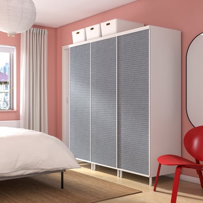 Grey PLATSA wardrobe with white top & boxes in pink bedroom.