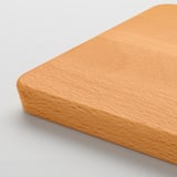 Smooth, high-quality wooden chopping board with rounded edges and a handle.