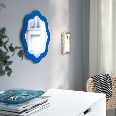 Round blue wavy-edge mirror, glass center, decorative wall decor.